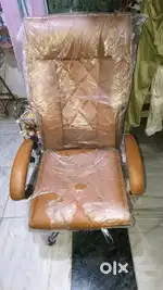brown cushioned office chair with a metal frame and armrests.