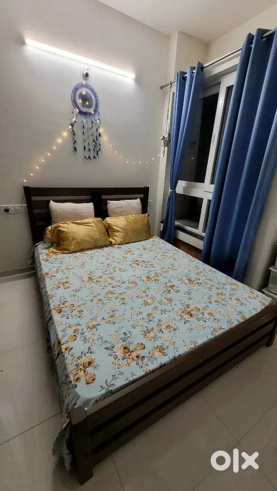 A queen bed with mattress