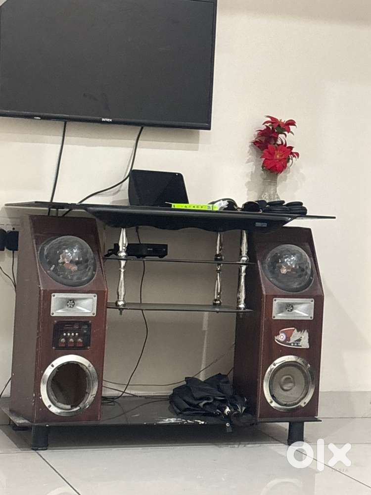 wooden TV stand with built-in speakers and disco lights