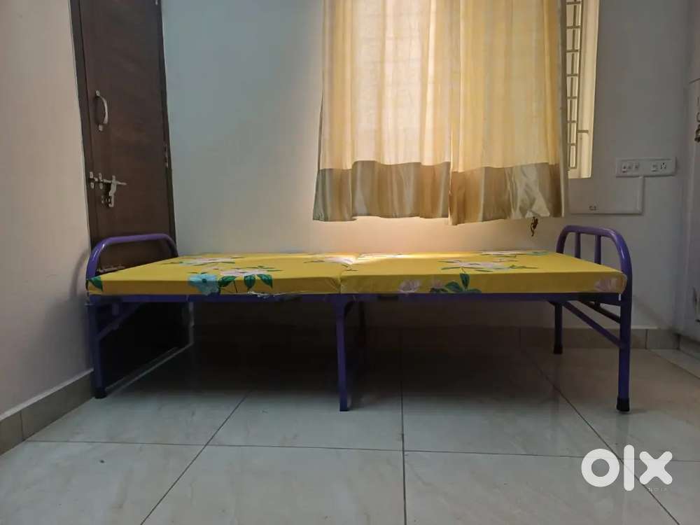 Foldable single steel cot with foam bed attached