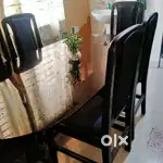Glass top dining table with six chairs
