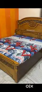 Wooden double bed with one side table