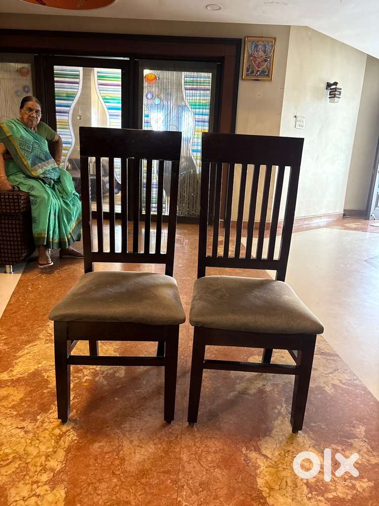 A set of seven brown coloured wooden chair