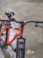 Orange coloured cycle with power brake