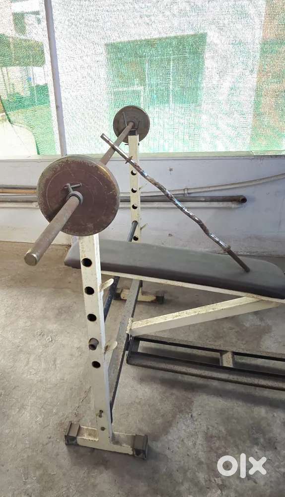 Bench press with iron rods and weights