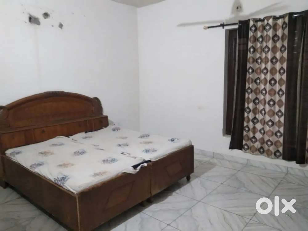 Bedroom with matters, almirah,chairs and wide kitchen