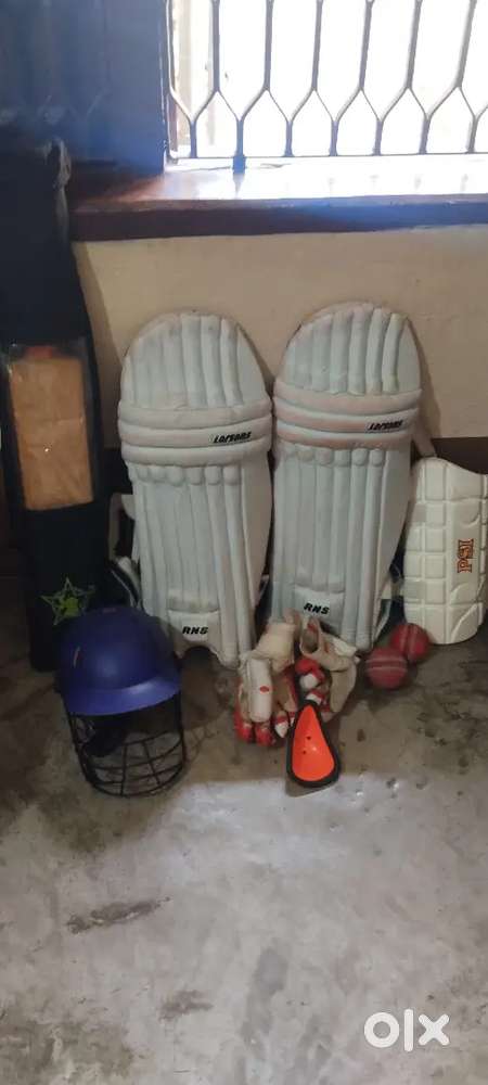 Cricket kit among with bat and ball