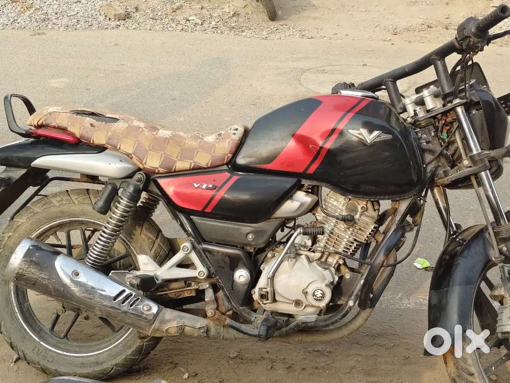 A mascular body and well maintained bike.