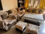 5 seater sofa with 2 puffs and centre table and cushions