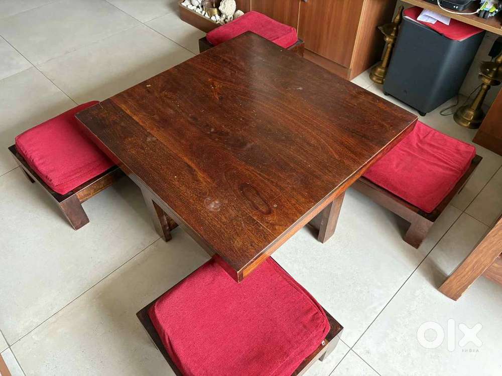 Solid wooden coffee table with 4 stools in excellent condition.