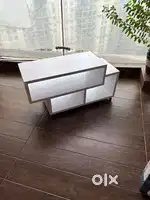 A wooden unit that can be used as a centre table or a book shelf