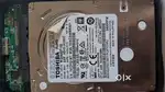 Toshiba 1TB hard disk with casing and high speed data transfer wire.