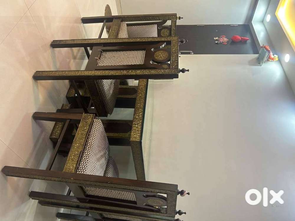 It is wooden built and table is covered with heavy square glass
