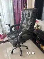 Old Revolving boss chair with scraches and tears