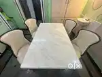 White marbled single stoned 4 seater dinning table.