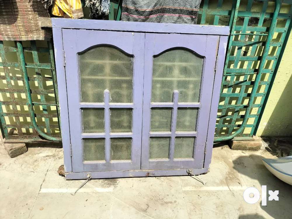 Wooden window frame with door and still grill