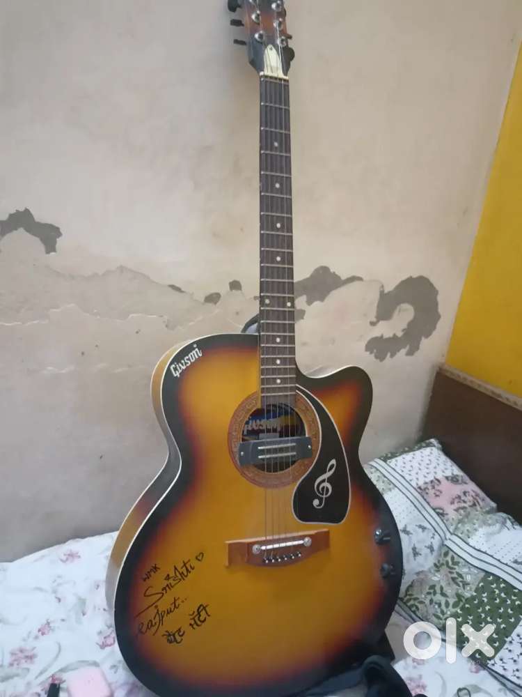 Guitar in orange and black colour in good condition