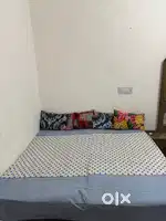wooden double bed with mattress