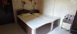 Double bed king size with side table.