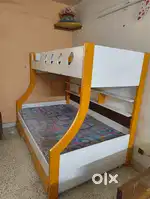 Bunker bed with mattress and a ladder.