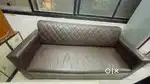 Elegant brown leather sofa with a diamond-patterned backrest