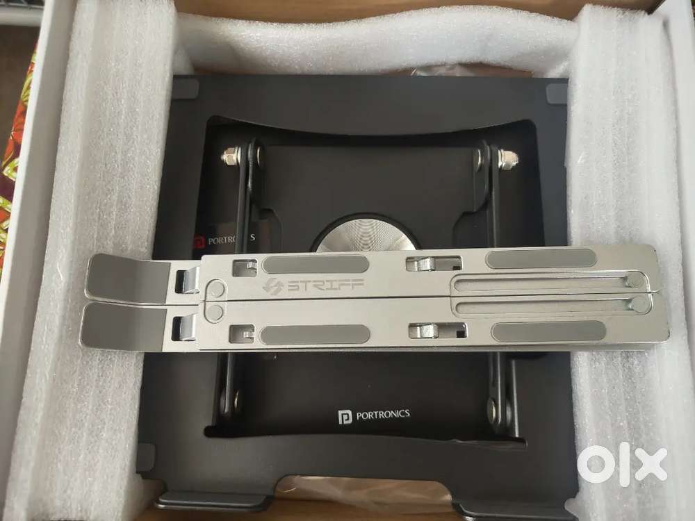 Rotating metal laptop stand with box.