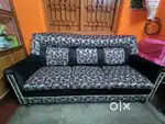 Black coloured sofa with covers available.
