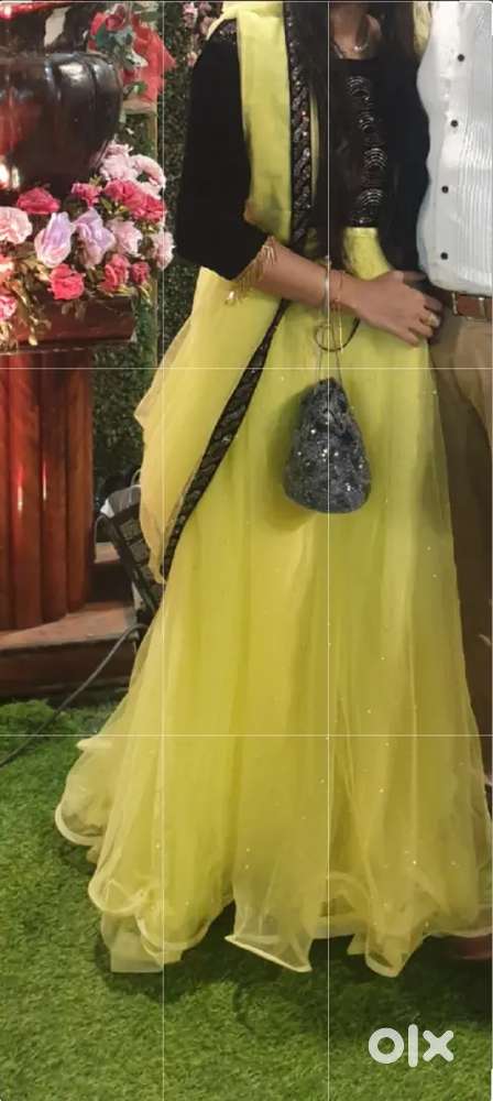Lime yellow lehenga with attached dupatta and velvet top