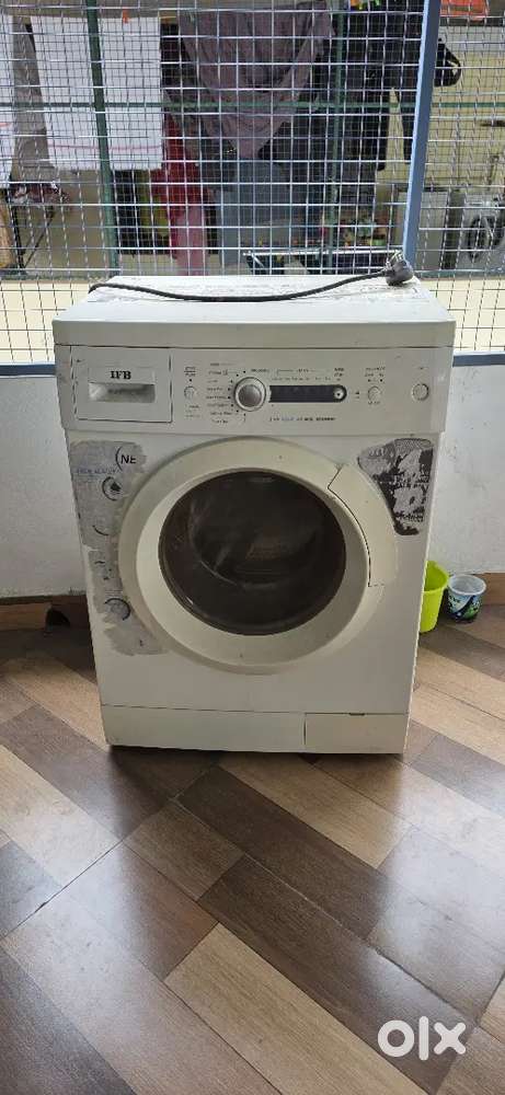8 year old front load washing machine. Drum is slightly damaged.