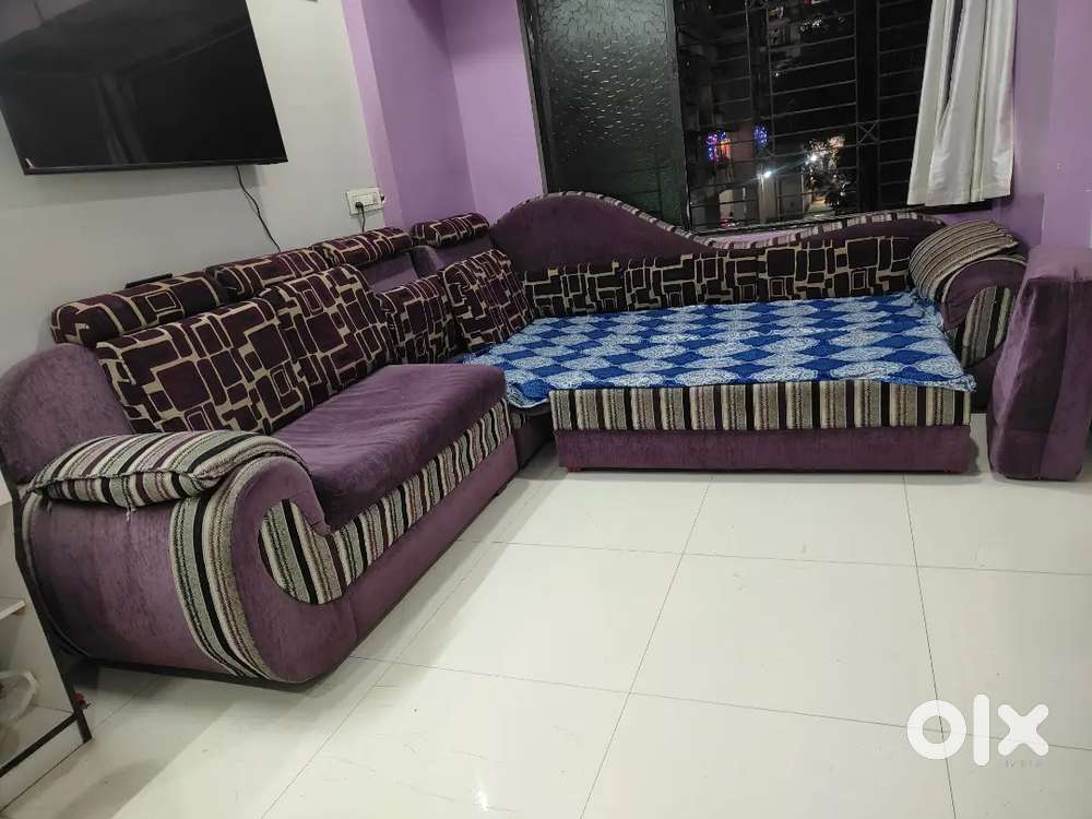 It's a purple colour L shape sofa cum bed