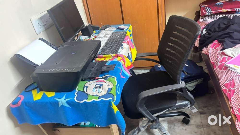 Computer desktop with printer and chair