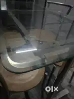 Glass top table with stainless steel chairs