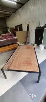 Brand new single metal bed with wooden ply on top