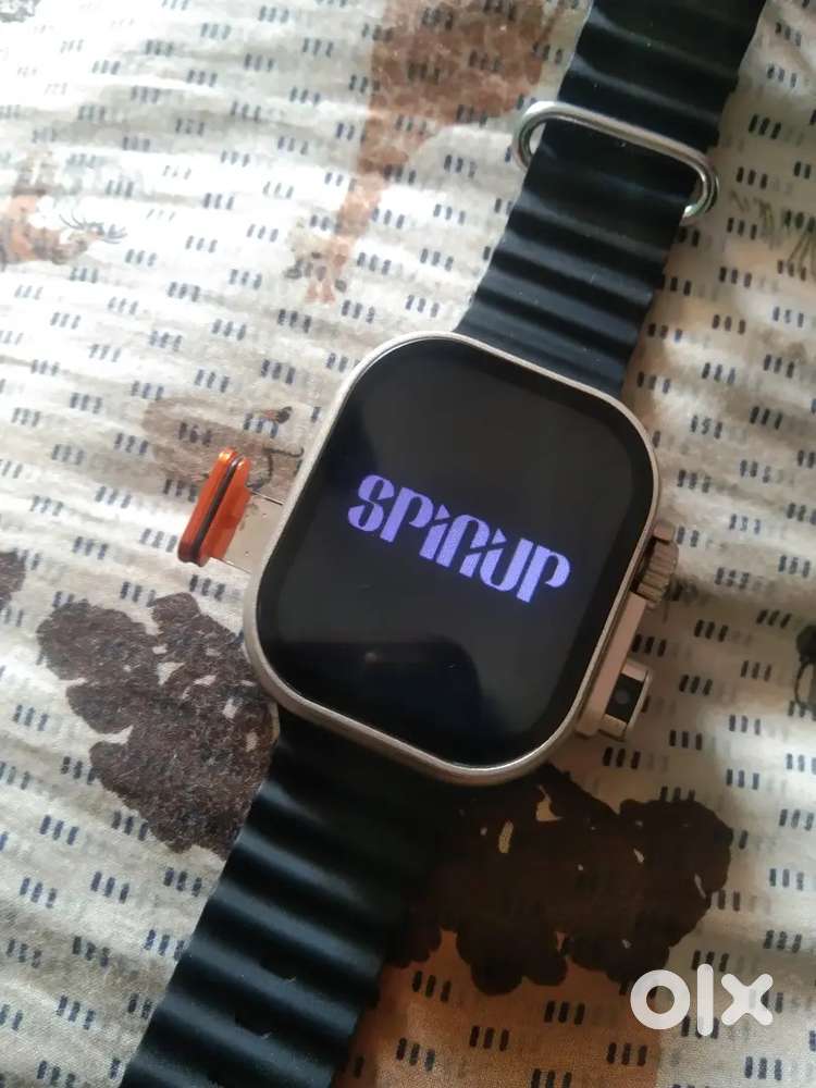 This is a generic smartwatch with a black silicone displaying SPINUP