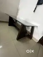 Wooden centre table with glass surface.