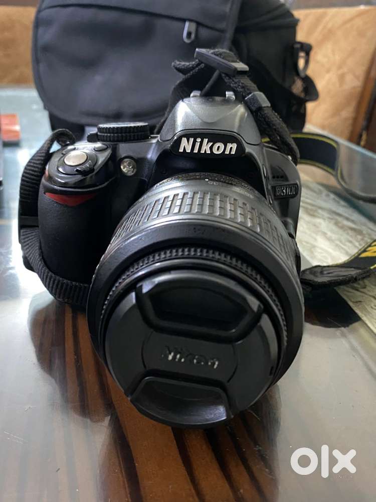 Nikon D3100 with charger bag lens cap camera strap and battery