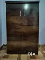 A cupboard with four stacks and a lock to keep items secure in it.