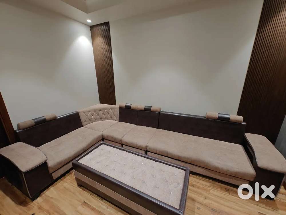 L shape sofa with centre table.