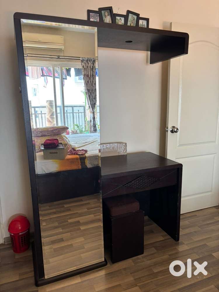 Spacious dressing table with a seating stool