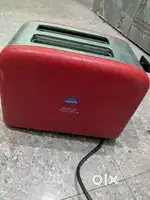 Table chair toaster and one gas stove also