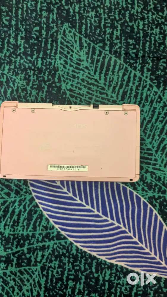 Nintendo 3ds with a game of 3ds and a Cartridge of pokemon red