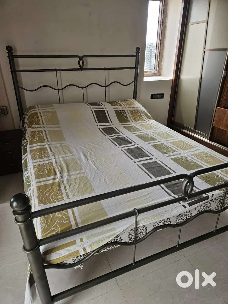 Bed with side table, mattress and cupboard