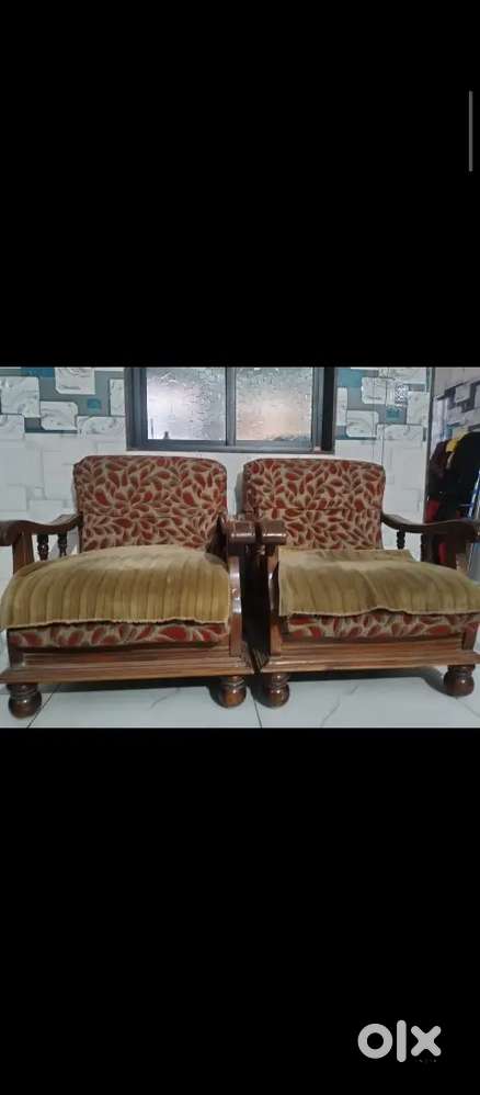 Sofa with two wooden chairs