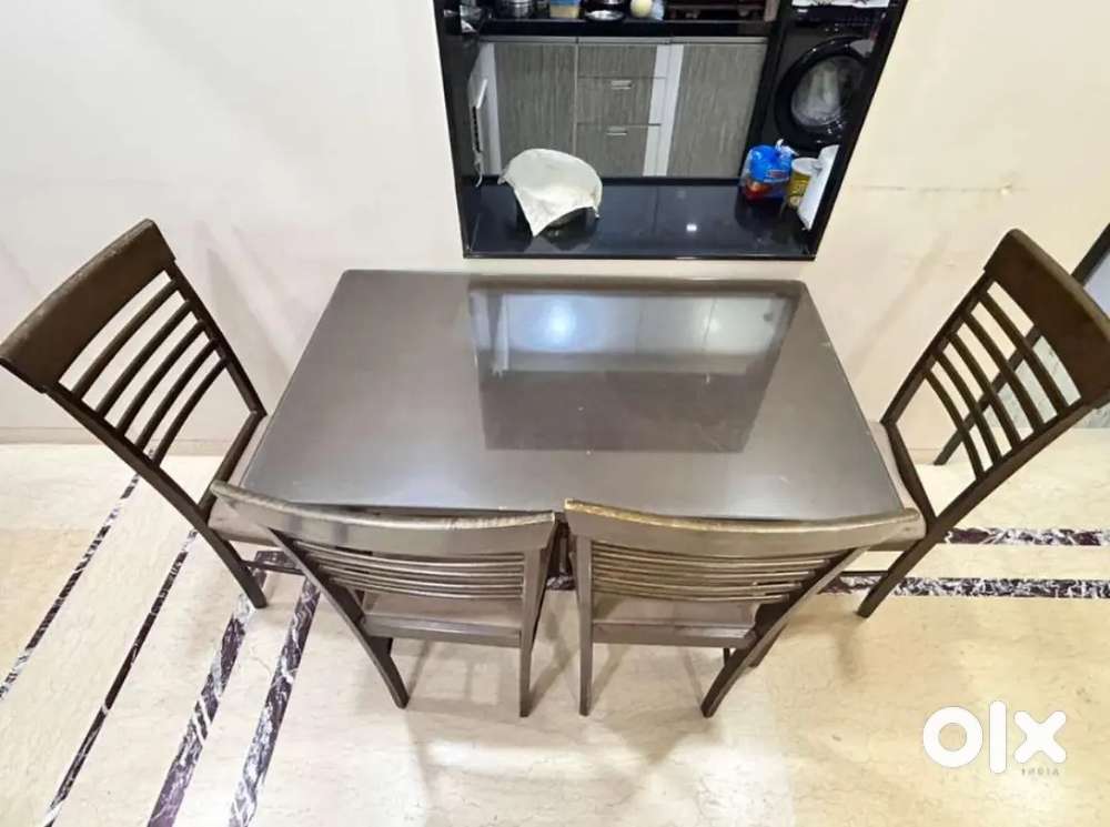 Wooden dining table with 4 cushioned chairs