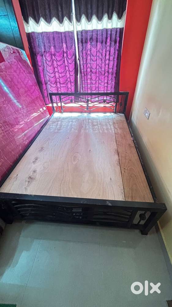 Selling a heavy-duty wrought iron bed with Plywood 7x6 size