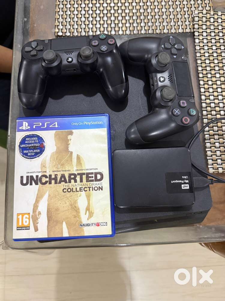 PS4 slim 500gb with 2 controller and a game disc