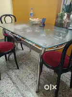 6 seater Glass dining table and steel base with 3 chairs