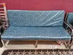 Sofa set with cushions and single bed.