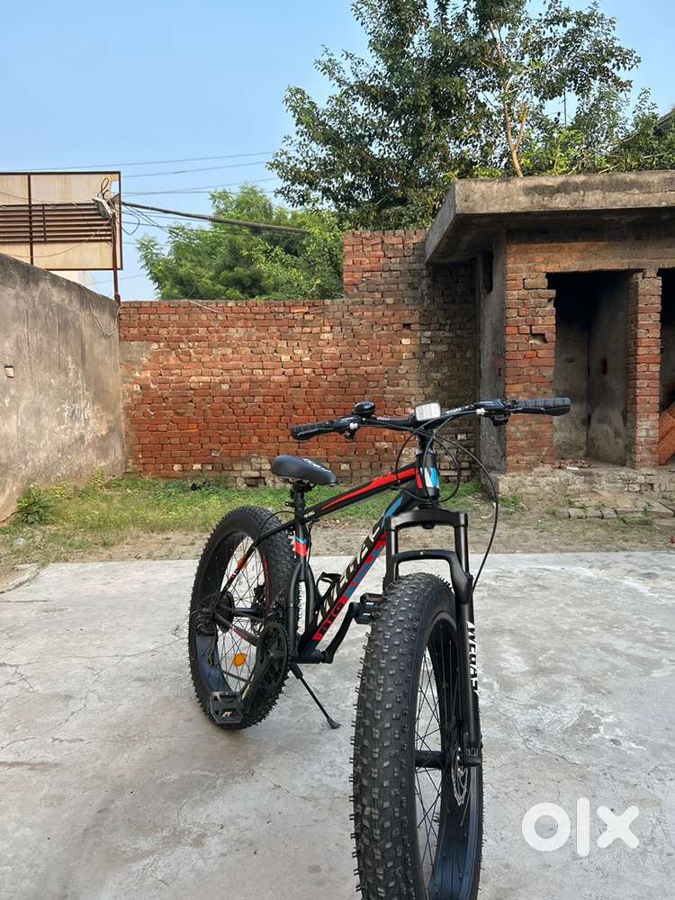 Matt black  bicycle with flat tyre