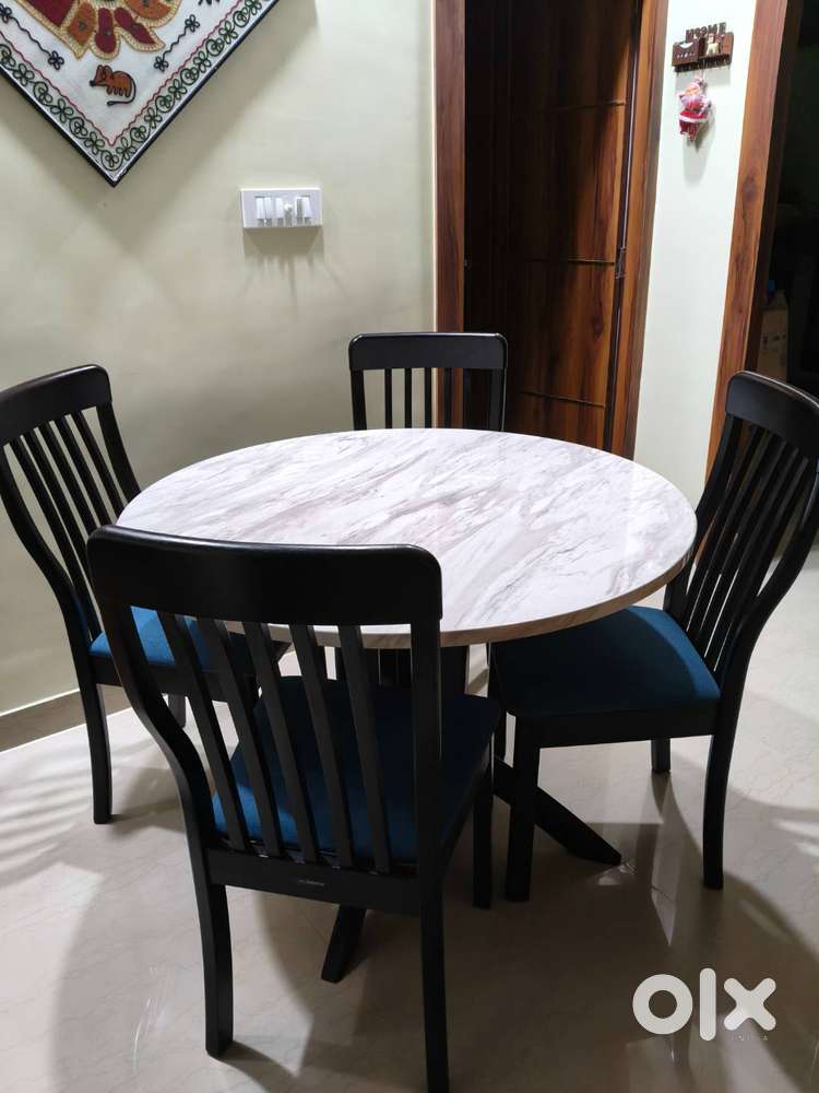 Godrej four seater Marbel top dining table with 4 chairs